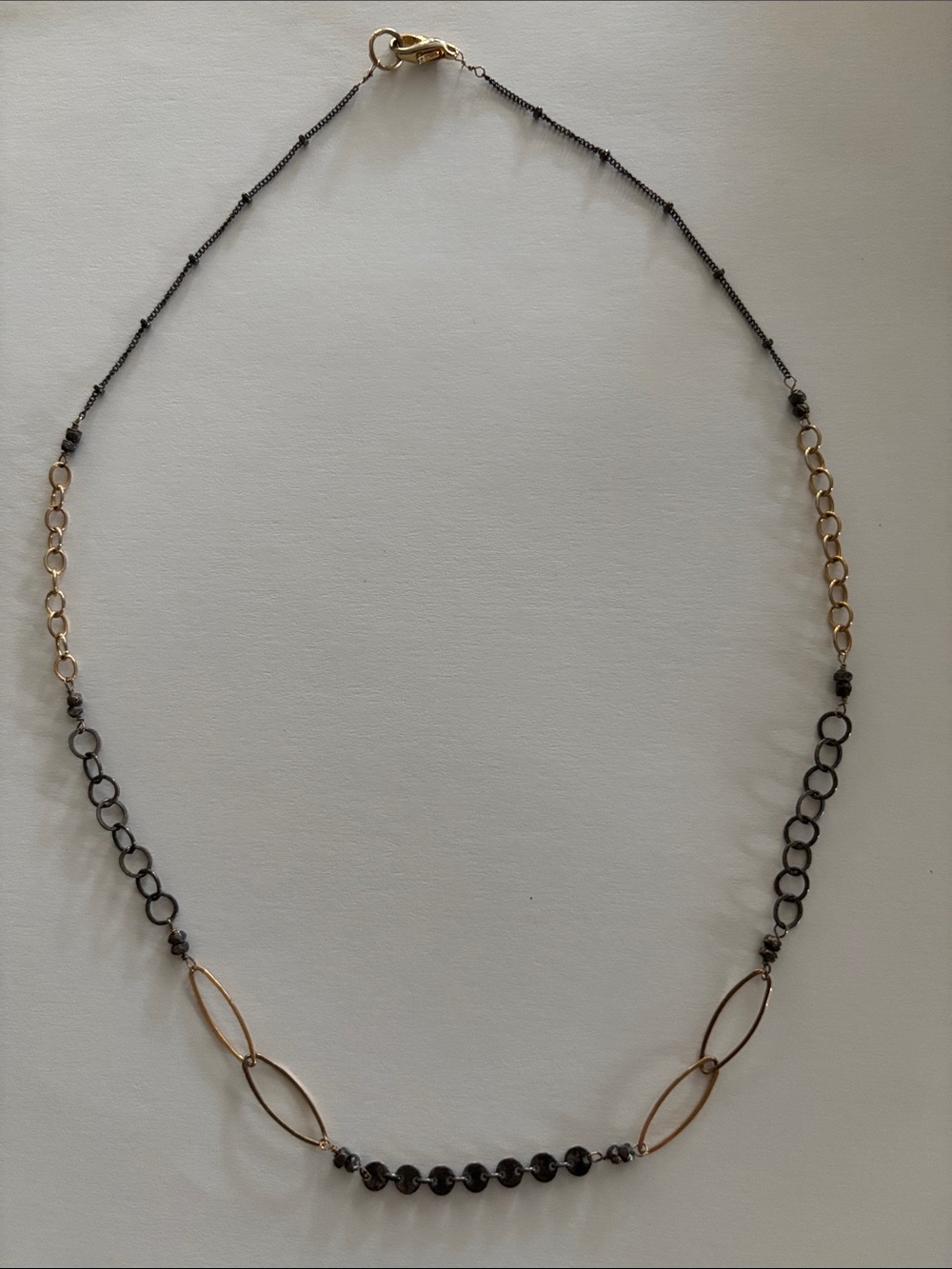 Delicate mixed metal handcrafted necklace purchased at Dandelion Jewelry